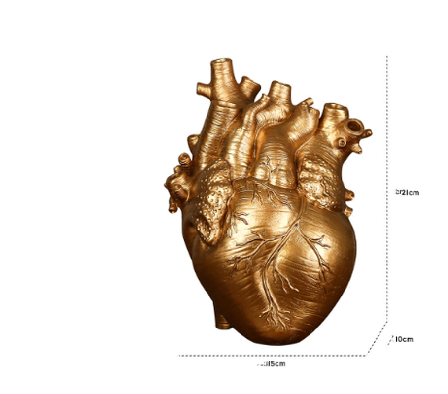 Golden heart-shaped sculpture with measurements on a white background with shipping to UK