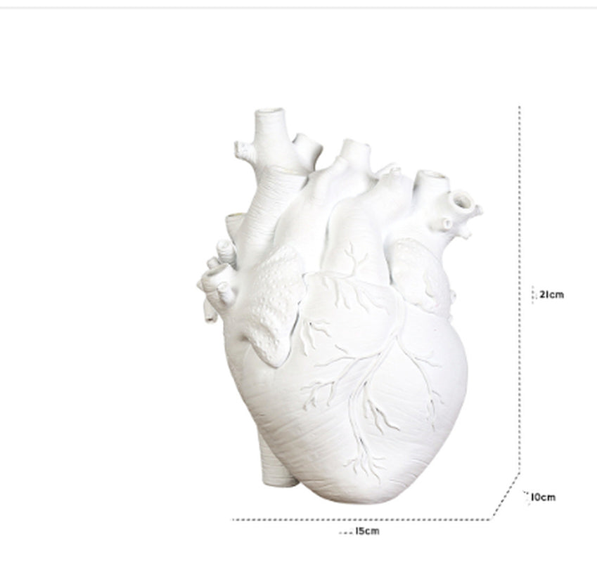 White heart-shaped object with measurements on a white background