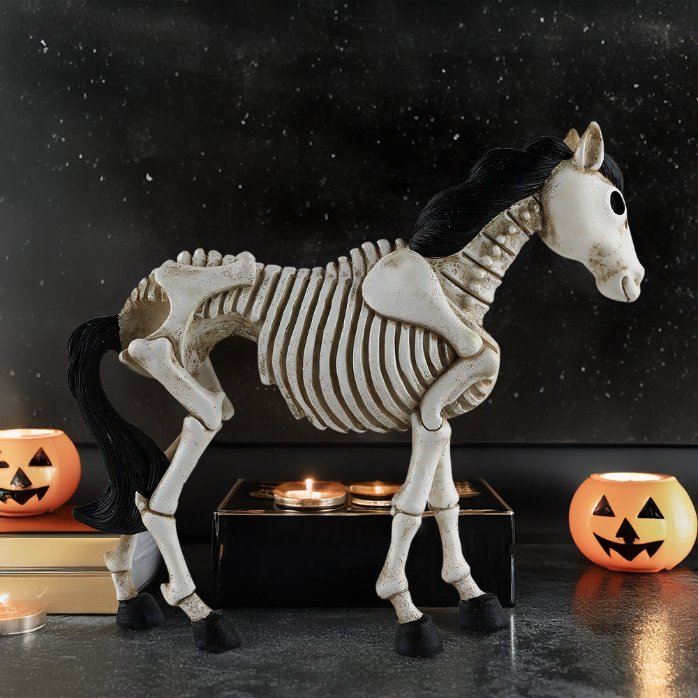Horse skeleton decoration with pumpkins and candles on a dark background