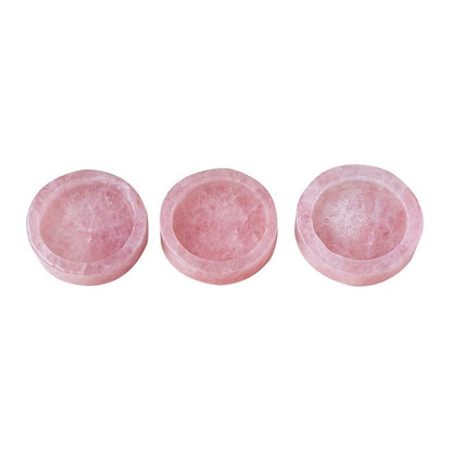 Three pink stone bowls on a white background
