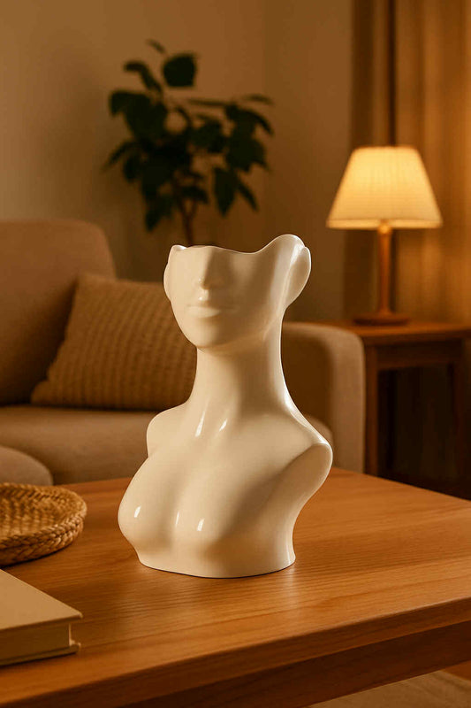 White ceramic bust on a wooden table in a cozy living room setting.