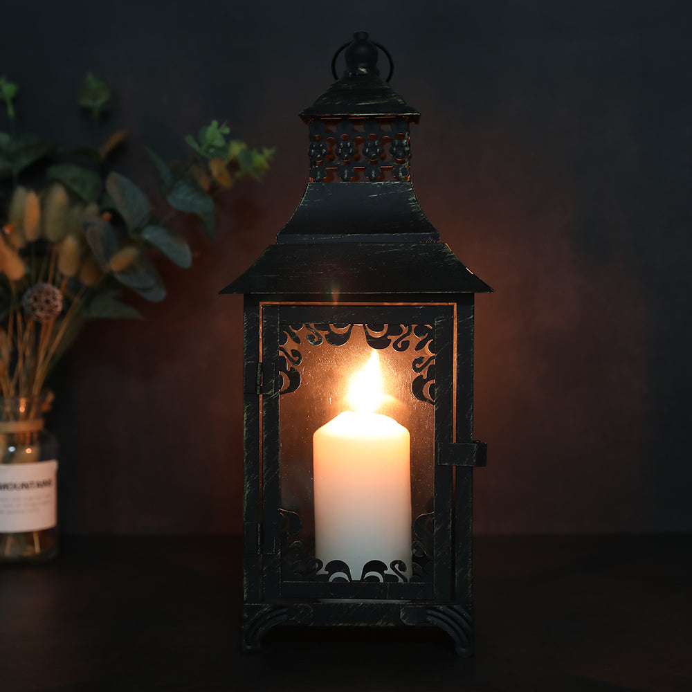 Decorative lantern with a lit candle inside on a dark background