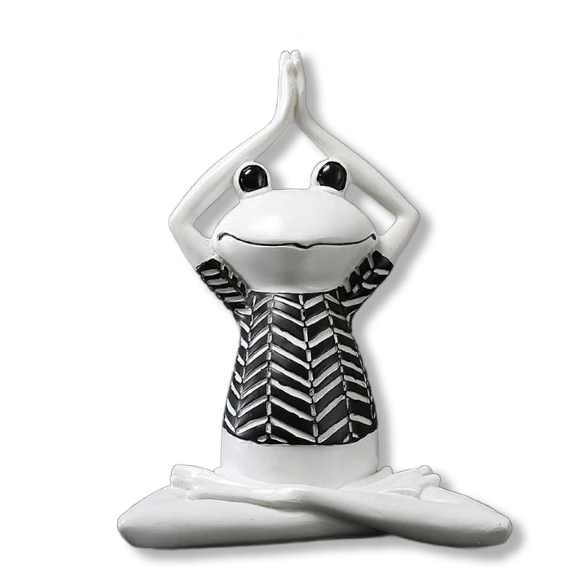 White ceramic frog figurine with black and white patterned shirt on a white background