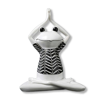 White ceramic frog figurine with black and white patterned shirt on a white background