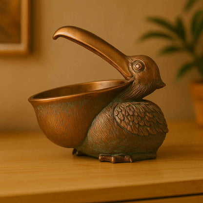 Bronze bird-shaped container on a wooden surface with a warm background