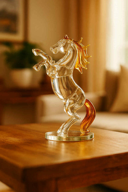 Glass horse figurine on a wooden surface with a blurred indoor background