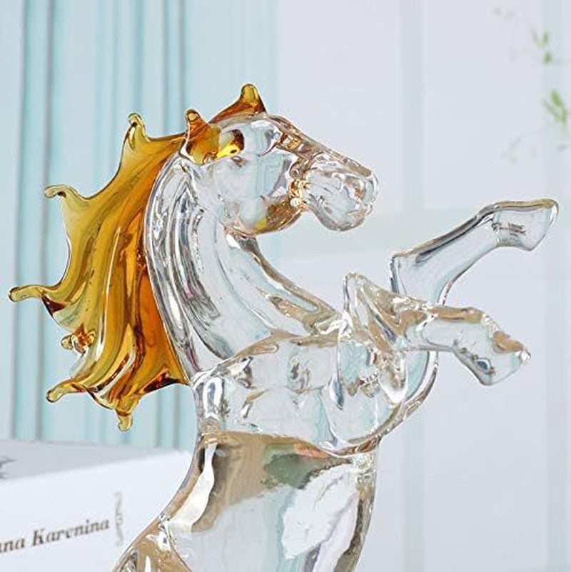 Glass horse figurine with gold accents on a light blue background