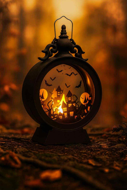 Decorative lantern with Halloween-themed cutouts in a forest setting