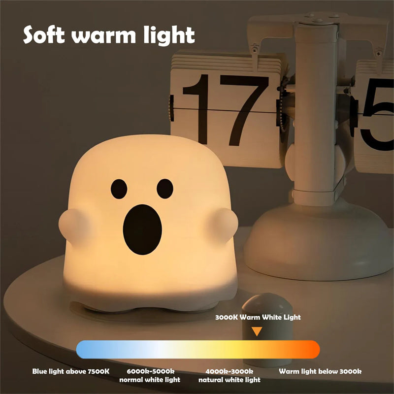 Ghost-shaped night light emitting soft warm light on a dark background