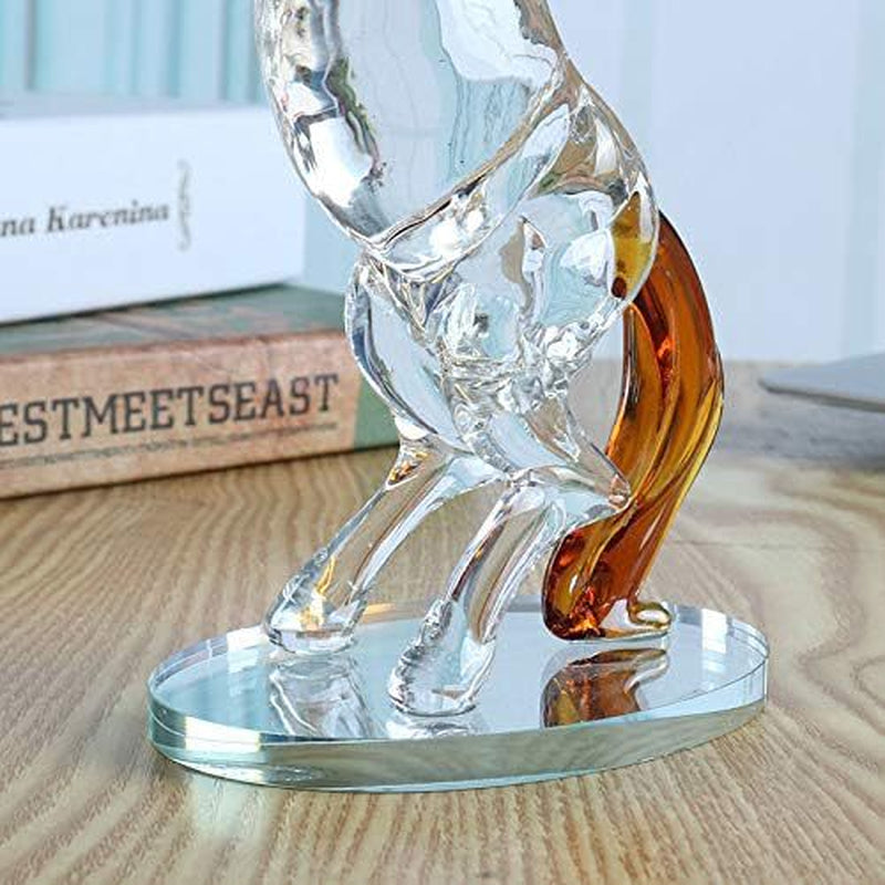 Crystal horse figurine on a wooden surface with books in the background