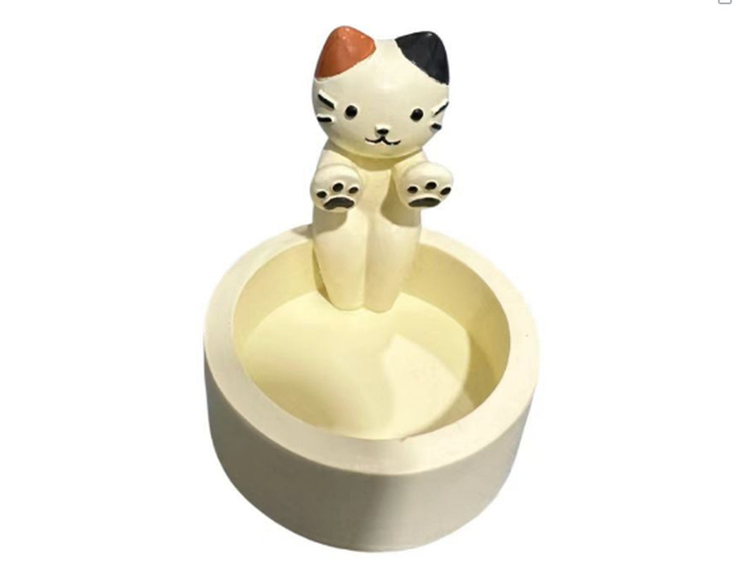 Cat-shaped ceramic product on a white background