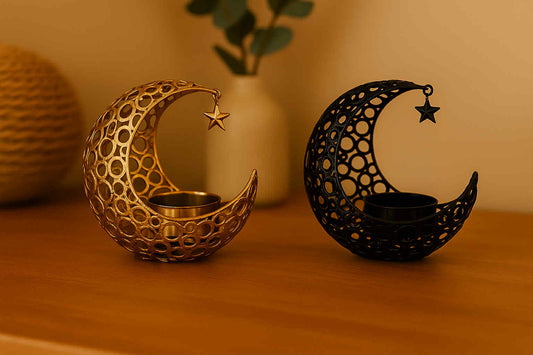 Decorative candle holders shaped like moons with star designs on a wooden surface.
