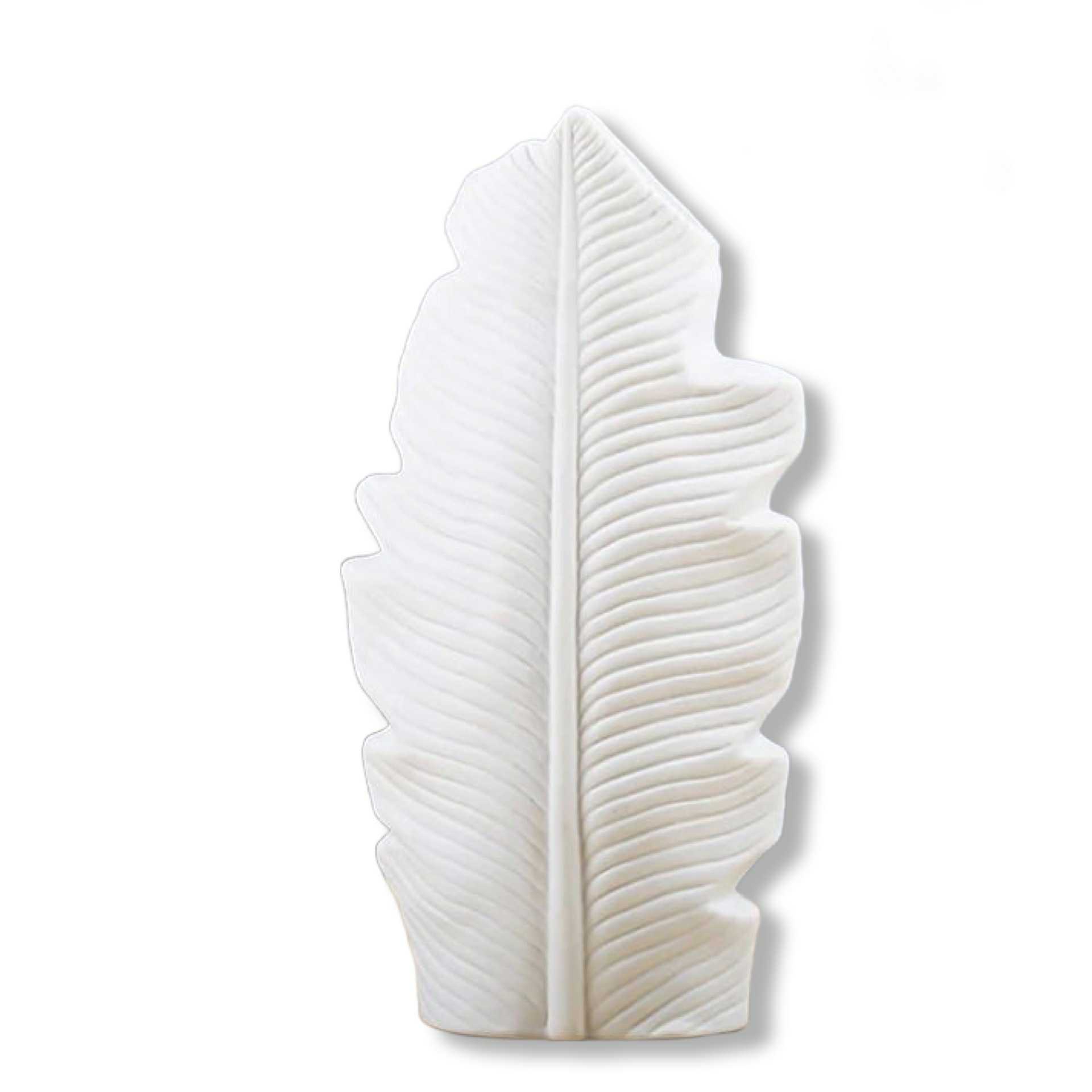 White ceramic leaf-shaped object on a white background
