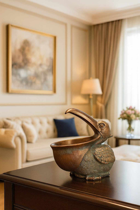 Decorative bronze bird sculpture on a table in a stylish living room.