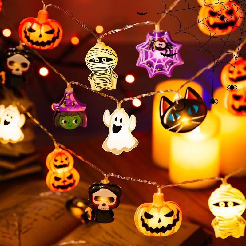 Halloween-themed string lights with various decorations on a dark background.