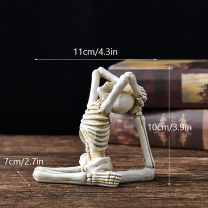 Skeletal yoga pose figure with measurements on a wooden surface